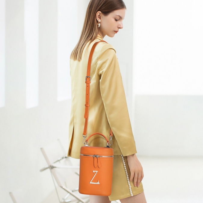 Bolso tipo cubo de cuero genuino de color naranja 2021 para damas con logotipo personalizado 